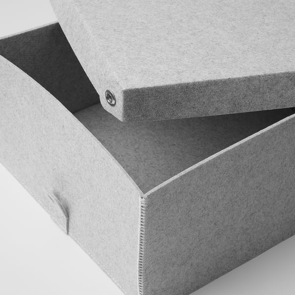 Closed light gray fabric box with lid, high-quality texture and stitching detail visible.