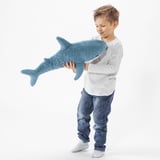 Boy holding large plush blue shark toy.