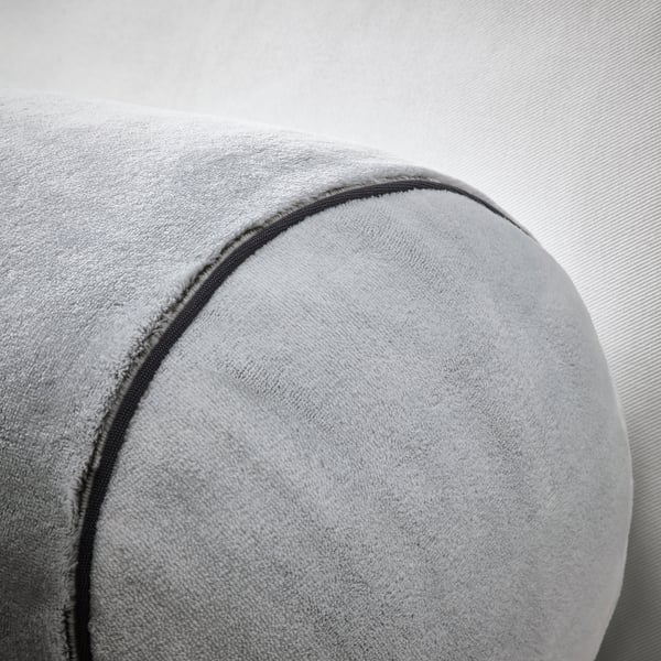 Soft grey cushion, circular shape, smooth fabric, detailed stitching, cozy and comfortable.
