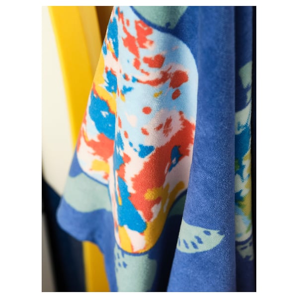 Blue, yellow, and orange turtle-patterned towel, soft cotton, hanging.