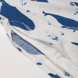 White duvet cover blue whale prints, offering a comforting touch. Its cotton fabric ensures temperature regulation for restful sleep.