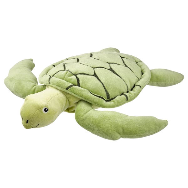 A light green, soft turtle stuffed toy with embroidered eyes.