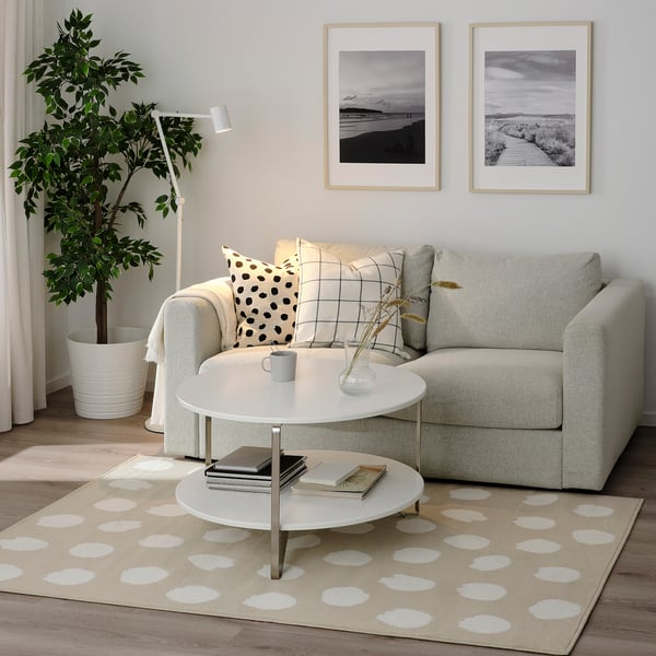 Living room with gray BOGENSE rug, white-dot pattern, gray sofa, and white coffee table.