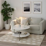 Living room with gray BOGENSE rug, white-dot pattern, gray sofa, and white coffee table.