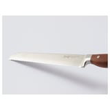 A high-quality knife with a sharp blade and wooden handle, made from stainless steel, displayed on a white surface.