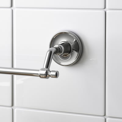 Chrome towel bar on white tiles, modern design with hidden screws.