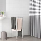 Silver BROGRUND towel stand with dark & light towels, folds flat for storage.
