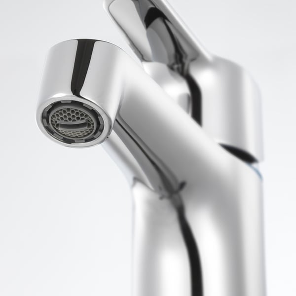 A high-quality chrome faucet with a sleek, modern design. The polished finish and intricate details of the aerator.