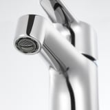 A high-quality chrome faucet with a sleek, modern design. The polished finish and intricate details of the aerator.