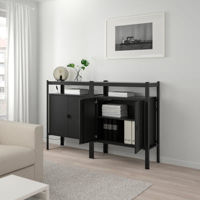 Black BROR unit in living room with books & couch.