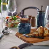 BRUGDHAJ blue jar on rustic table, smaller than wine glass, holds spices or sauces.