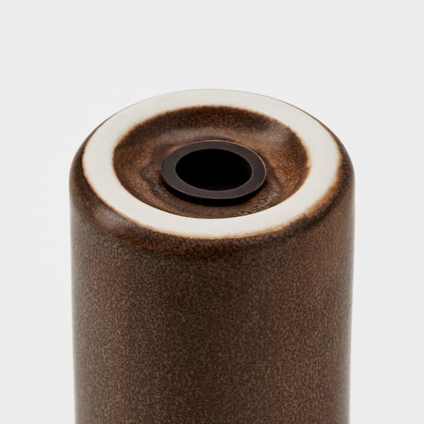 Cylindrical stoneware container with rustic, glazed finish. Top has round opening, likely for pouring contents.