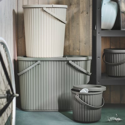 Three stacked DAMMÄNG bins: gray striped, showcasing size variation, perfect for waste sorting.