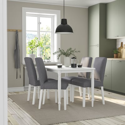 Modern dining set with white table, grey chairs, hanging lamp, and window.