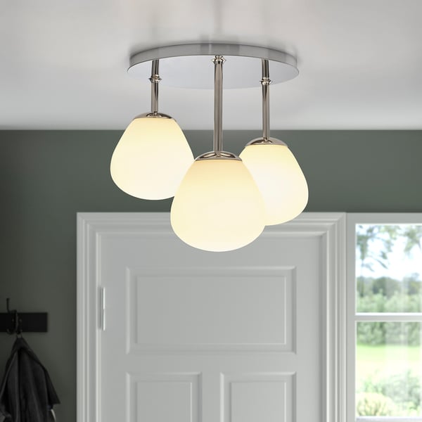 A ceiling light fixture with three spherical, opal glass shades and chrome details, providing soft, dimmable light.