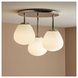 Three opal glass globes in chrome ceiling light, DEJSA series, soft light.