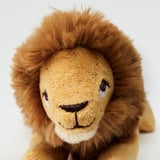 Small plush lion toy, soft and huggable, made from recycled materials, ideal for childrens play and comfort.