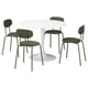 A DOCKSTA dining set with a white round table and four green chairs. The chairs have a metal frame and a curved backrest for comfort.