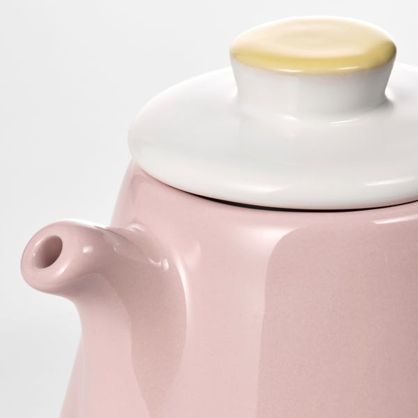 Close-up of a pastel pinkDUKTIG teapot with a white lid.