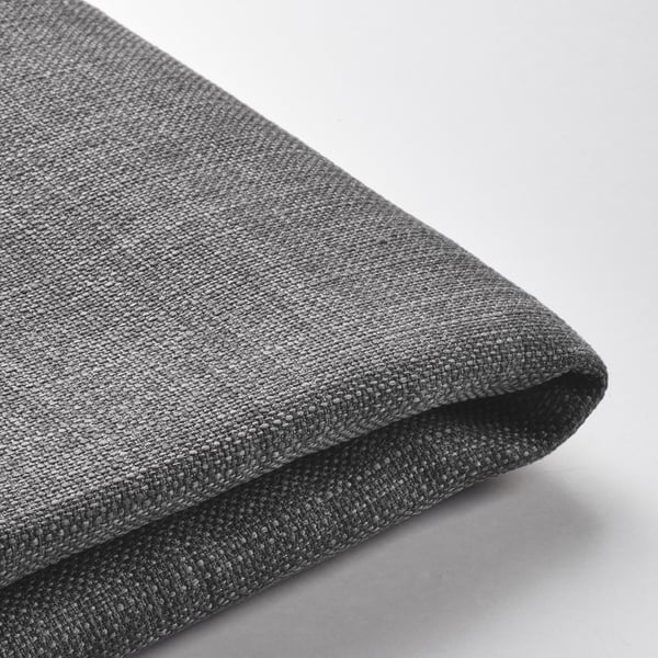 A folded grey fabric, possibly a cushion cover, showcasing its smooth texture and neat stitching.