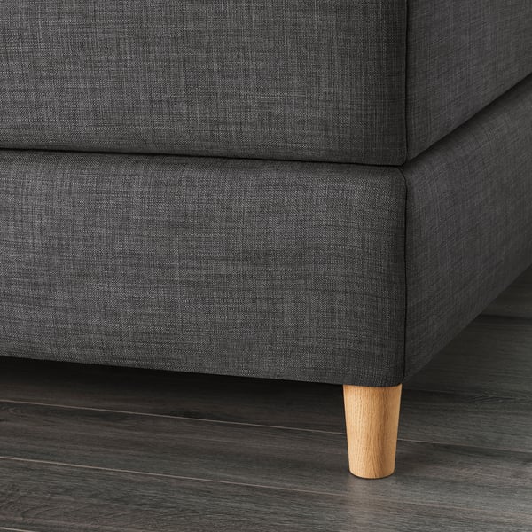 Dark grey upholstered bed with wooden legs, showcasing quality fabric and sturdy construction.