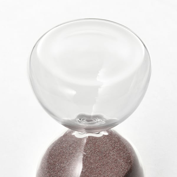 Clear glass hourglass with smooth, rounded top and base, reflecting light gently.