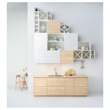 Modern minimalist kitchen with custom EKBACKEN light wood worktop. White cabinets, built-in sink, and dish racks.