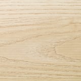Close-up of a smooth, light-colored wooden surface, likely a kitchen worktop, showcasing its sleek, easy-to-clean, and polished texture.