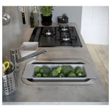 Grey EKBACKEN countertop with sink, gas stove, and broccoli.