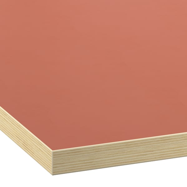 Close-up of a smooth, vibrant orange laminate worktop, showcasing its clean edges and quality finish.