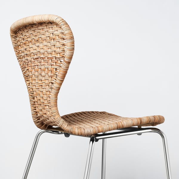 Modern rattan chair with metal base. Intricately woven seat and backrest. Sleek, stylish design.
