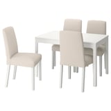 White extendable dining table with four light beige chairs. Modern, minimalist design with clean lines and wooden legs.