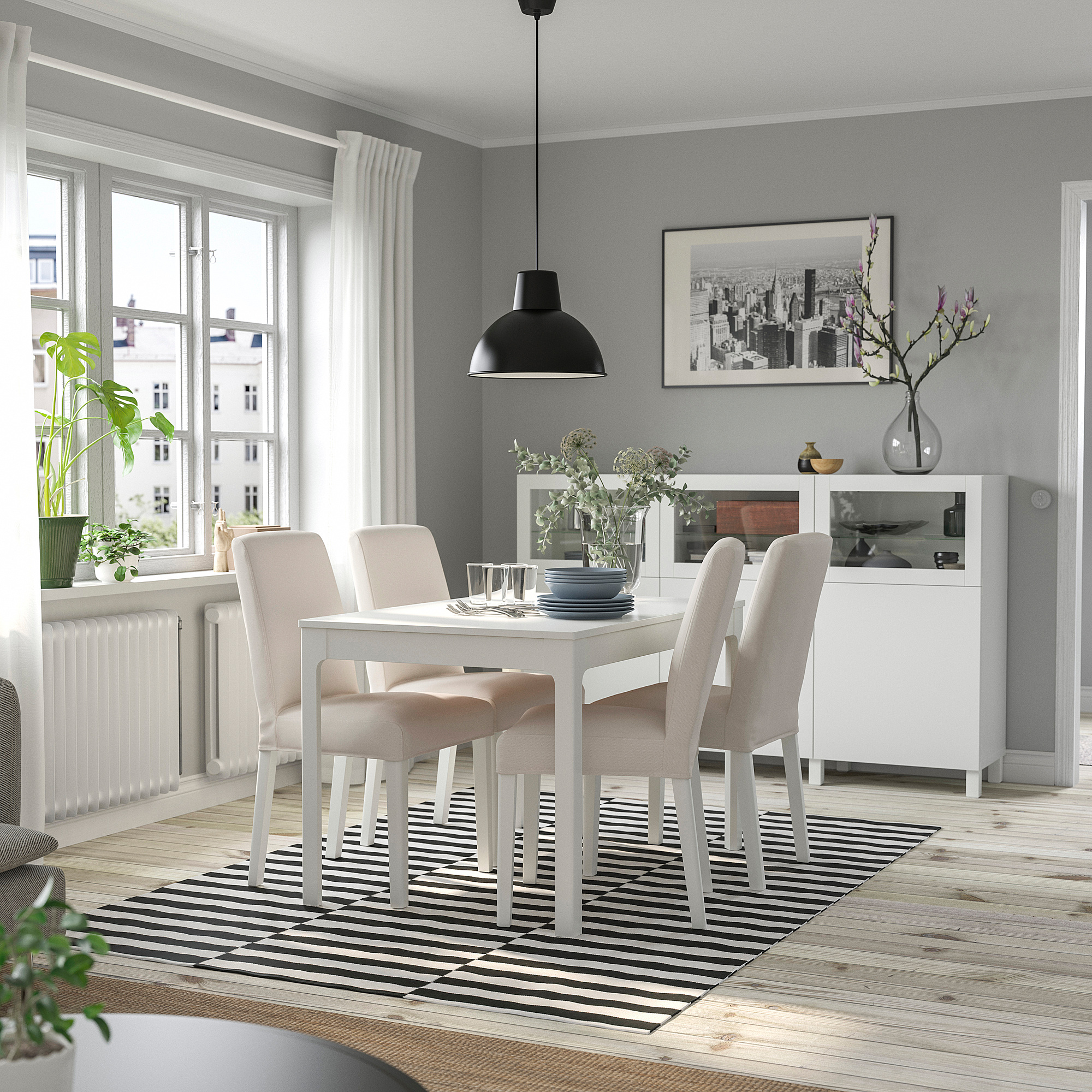 Minimalist EKEDALEN dining table with four chairs, striped rug, and sideboard in a cozy, contemporary dining space.