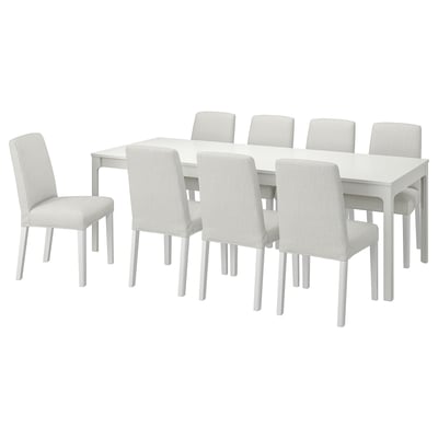 A white EKEDALEN dining set with an extendable table and six fabric chairs.