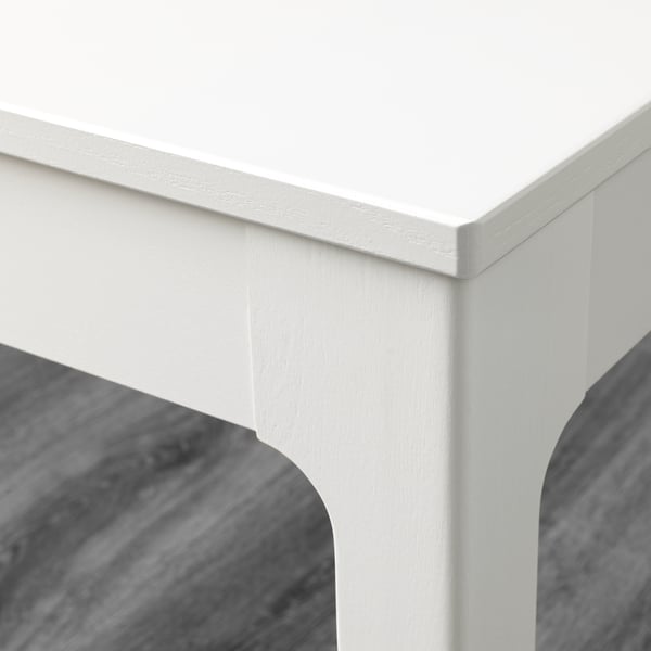 Clean, white table corner, smooth finish, sturdy build quality.