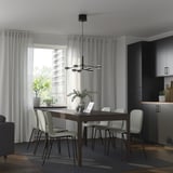 Modern dining room with expandable table, 6 chairs, minimalist decor, and cabinet.