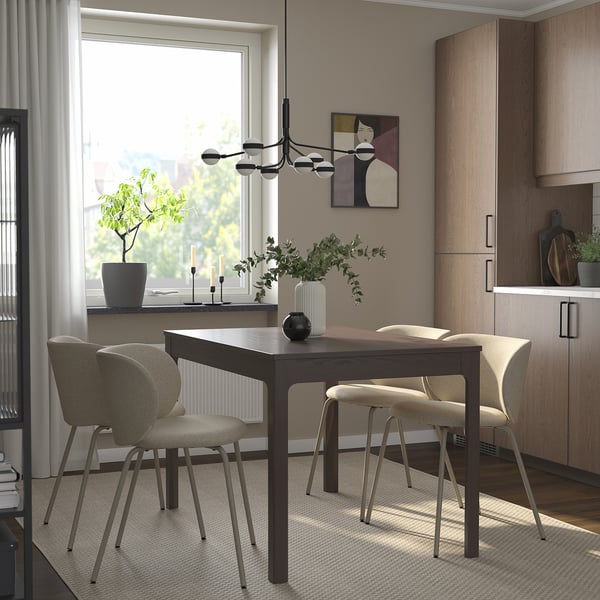 EKEDALEN extendable dining set with dark wood table, beige chairs, natural light, pendant light, warm decor.