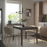 EKEDALEN extendable dining set with dark wood table, beige chairs, natural light, pendant light, warm decor.