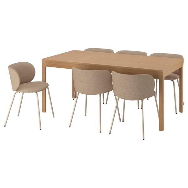 Modern brown extendable wooden dining table with six beige fabric chairs.