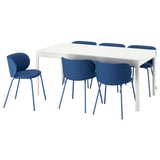 Modern white rectangular dining table with six blue cushioned chairs, sleek design, extendable.