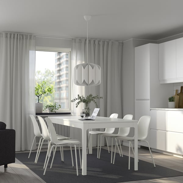 Minimalist dining area with EKEDALEN table, chairs, and pendant light. Large window with natural light.