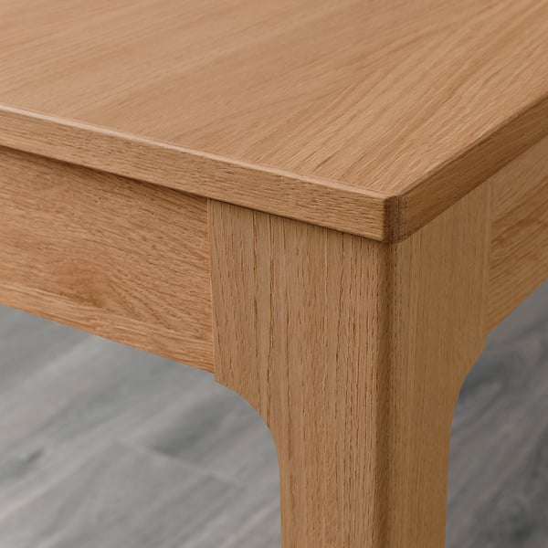 Clean-lined oak table edge, smooth finish, sturdy leg joint.