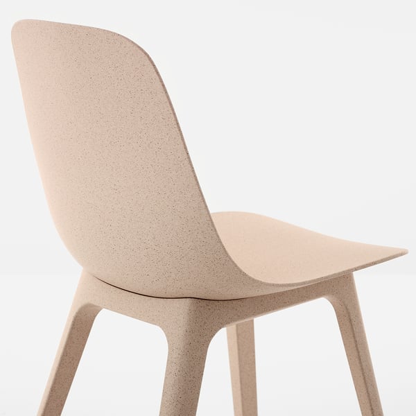 Modern chair with a sleek, minimalist design, featuring smooth curves and a uniform, light-colored texture.