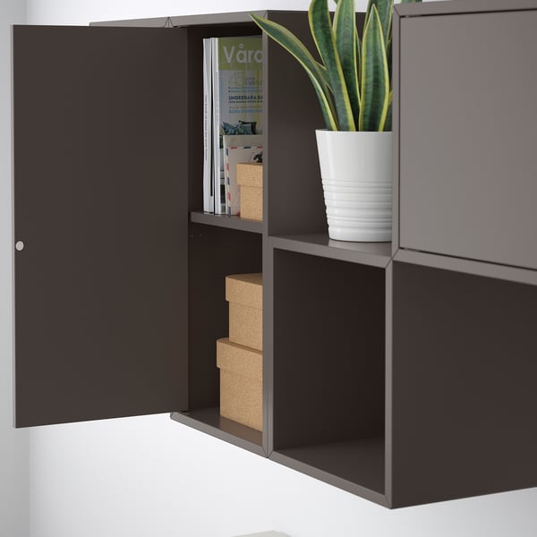 Open EKET wall cabinet displays storage boxes and a potted plant.