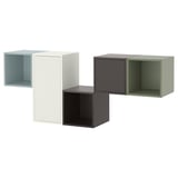 Modern wall-mounted storage system. Four cubes in light blue, white, gray, and green. Made from particleboard and metal. Unique, colorful design.