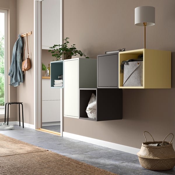 Modern wall-mounted EKET cabinets in multicolors: yellow, green, black. Floor: stool, basket.