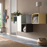 Modern wall-mounted EKET cabinets in multicolors: yellow, green, black. Floor: stool, basket.