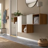 Modern entryway with wall-mounted EKET storage in beige & wood, mirror & lamp.