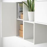 White EKET units: one with magazines, other with plant.