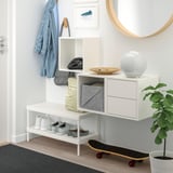 Modern entryway with EKET storage, mirror, plants, and skateboard.